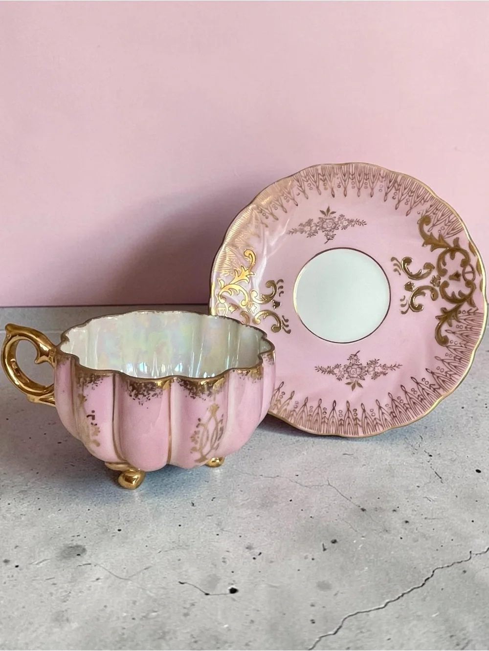 Lusterware teacup & saucer, melon shaped cup on 3 gilded feet, iridescent